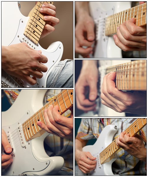Guitarist playing an electric guitar - Stock Photo